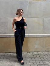 a lady wears black loose fit pants